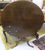 A 19th Century mahogany tilt-top circular tea table raised on pedestal tripod base
