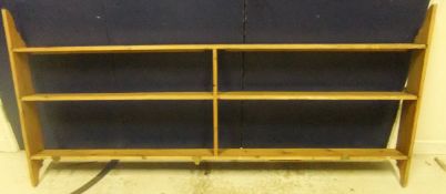 A pine wall shelf unit of three tiers