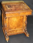 A Victorian walnut Davenport desk with brassed galleried top
