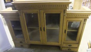 A modern pine breakfront dresser top with four glazed doors and four drawers