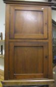 A Victorian mahogany wall hanging corner cabinet of two doors enclosing shelves