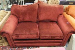 A modern scroll arm two seat sofa upholstered in burgundy striped chenille type fabric
