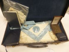 A Masonic case containing apron, 9 carat gold ring and pin,