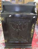 A carved oak wall hanging cupboard enclosing two shelves,