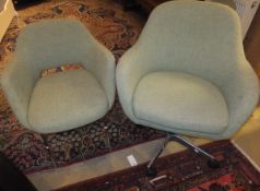 A set of six upholstered office elbow chairs on tubular chromed supports,