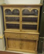 A 19th Century pine dresser, the two glazed doors over two drawers and two cupboard doors,