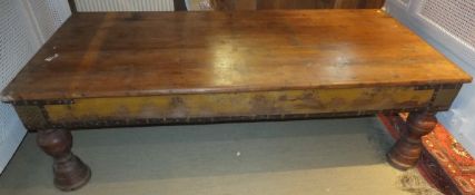 A 20th Century Indian teak coffee table on turned supports