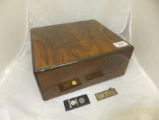 A Dunhill walnut humidor, together with a silver cigar cutter and a Bentley's Seafood Restaurant