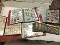 A collection of various stamp albums, postcard albums, coins etc CONDITION REPORTS Cigarette cards