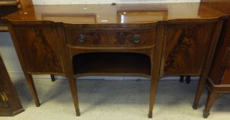 An Edwardian mahogany serpentine fronted sideboard in the George III taste,