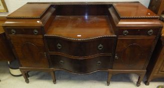 A Sheraton style mahogany serpentine fronted sideboard,