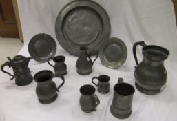 A quantity of 18th Century and later pewter plates, mugs, measures, a one gallon measure, lidded mug