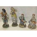 A pair of Dresden porcelain figures depicting a gentleman playing hurdy gurdy and a lady playing