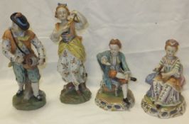 A pair of Dresden porcelain figures depicting a gentleman playing hurdy gurdy and a lady playing