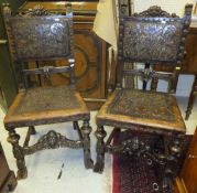 A pair of 19th Century Spanish tooled and painted leather upholstered standard hall chairs on