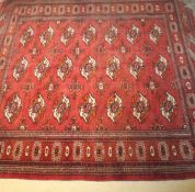 A Bokhara rug, the repeating elephant foot medallions in red,