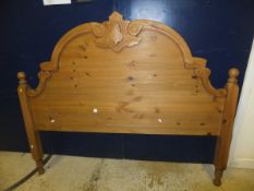 A pine double headboard together with a single guest mattress and frame