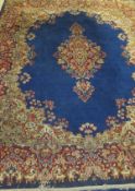 A Persian carpet, the central floral medallion in burgundy, cream, pink,