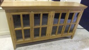 A modern teak four door glazed display cabinet on square tapered legs CONDITION REPORTS Some light
