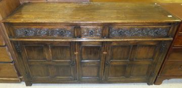 A reproduction oak enclosed dresser in the 17th Century manner,