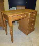 A pine dressing table of five assorted drawers,