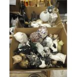 A box containing various cat figurines and a box containing assorted cat doorstops,