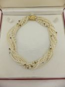 An eight strand pearl necklace with 18 carat gold clasp