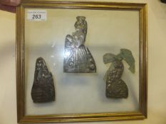 Three silvered copper pilgrim badges (housed in a glazed frame)