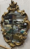 A 20th Century carved giltwood framed Rococo style wall mirror