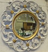 A modern painted and gilded circular wall mirror with bevel edged plate in the 19th Century manner
