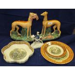 A pair of Staffordshire pottery greyhounds with prey,