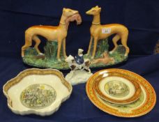 A pair of Staffordshire pottery greyhounds with prey,