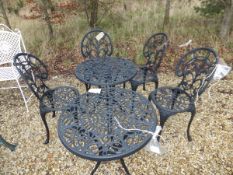 Two cast metal painted garden tables and four matching chairs with cushions