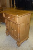 A pine cupboard with single drawer above two cupboard doors with various applied moulding and