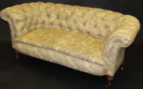 A late 19th Century buttoned back Chesterfield style sofa in pale beige upholstery with classical