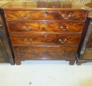 A late George III mahogany gentleman's chest of four long graduated drawers with brass swan neck