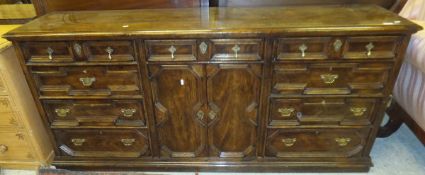 A modern oak dresser in the 18th Century manner with single central drawer above two cupboard doors,