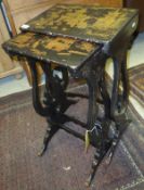 A 19th Century nest of two black lacquered and Chinoiserie decorated side tables with lyre end