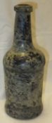 A circa 1800 black glass wine bottle