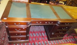 A modern mahogany partner's desk with leather insert top,