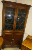 A 19th Century North Country oak and cross-banded corner cupboard,