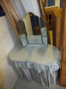 A kidney-shaped dressing table with three part mirror,