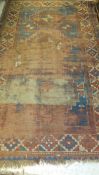 A Caucasian prayer rug in aubergine, blue, madder and pale orange,
