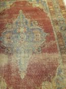 A Bokhara rug, the central elephant foot medallions in cream,