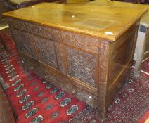 An 18th Century oak mule chest with later carved decoration
