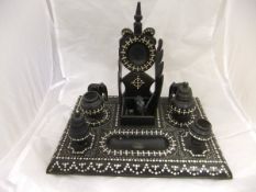 A late 19th / early 20th Century Anglo-Indian ebony and ivory inlaid desk stand