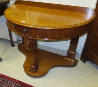 A Victorian mahogany demi-lune side table on monopodia platform support