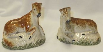 A pair of early 19th Century Staffordshire figures of recumbent horses (hollow bottoms) CONDITION