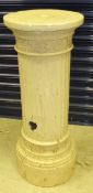 A cream painted fluted column,