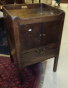 A 19th Century mahogany night table with tray top above two cupboard doors and a single drawer to